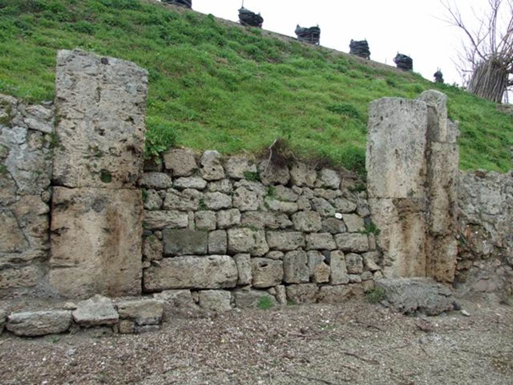 IV.2.a  Pompeii. March 2009. Entrance. According to Liselotte Eschebach, there was a Lararium painting here. This was a painting of Mercury with cloak, petasos (hat), winged sandals. In his left he had a caduceus and in his right a marsupium. In front of the god was an omphalos with a serpent winding around it.  On the right was a high round pillar with a cockerel on top of it.  She suggested this may possibly be F28 identified by Fr�hlich as from Regio IV.
See Fr�hlich, T., 1991. Lararien und Fassadenbilder in den Vesuvst�dten. Mainz: von Zabern. (p.316, F28).
See Eschebach, L., 1993. Geb�udeverzeichnis und Stadtplan der antiken Stadt Pompeji. K�ln: B�hlau. (p.116, IV.2.1).
