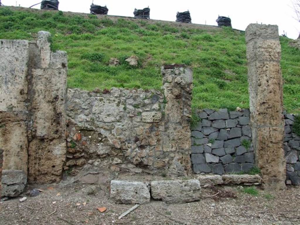 IV.2.b Pompeii. March 2009. Entrance doorway, with remains of a bench on the west side of it. According to Sogliano, this doorway noted for its square blocks of Sarno stones led to an entrance corridor flanked by two cubicula. The one on the right was decorated with beautiful stucco. Found there on 27th December 1902 were the remains of a human skeleton. Found on 29th December 1902 was a terracotta lamp decorated with a tragic mask. See Notizie degli Scavi di Antichit�, 1905, (p.280). According to CTP, it was definitely the house at b with the two cubicula near its entrance that was mentioned by Sogliano. See Van der Poel, H. B., 1986. Corpus Topographicum Pompeianum, Part IIIA. Austin: University of Texas. (p.68). According to Luongo et al, the skeleton was found to the right of the entrance in House d. See G. Luongo et al: Impact of the AD79 explosive eruption on Pompeii, in Journal of Volcanology & Geothermal Research 126 (2003) (p.185).