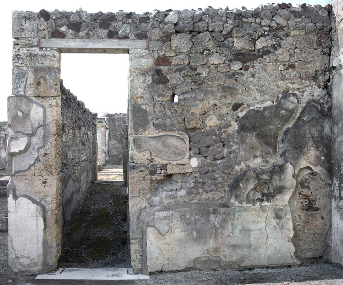 V.1.7 Pompeii. c.2005-7.
Room 9, north wall of east ala, with doorway to corridor 10 leading to peristyle “b”.
Photo by Hans Thorwid.
Photo courtesy of the Swedish Pompeii Project.