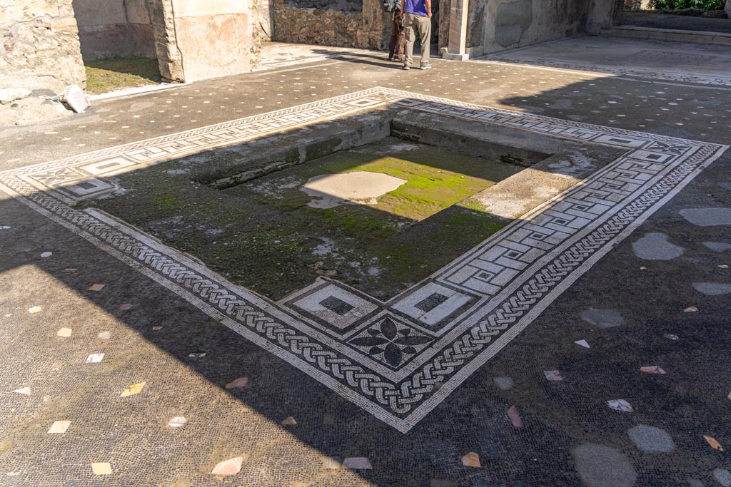 V.1.26 Pompeii. October 2023. Room “b”, looking north-east across impluvium in atrium. Photo courtesy of Johannes Eber.