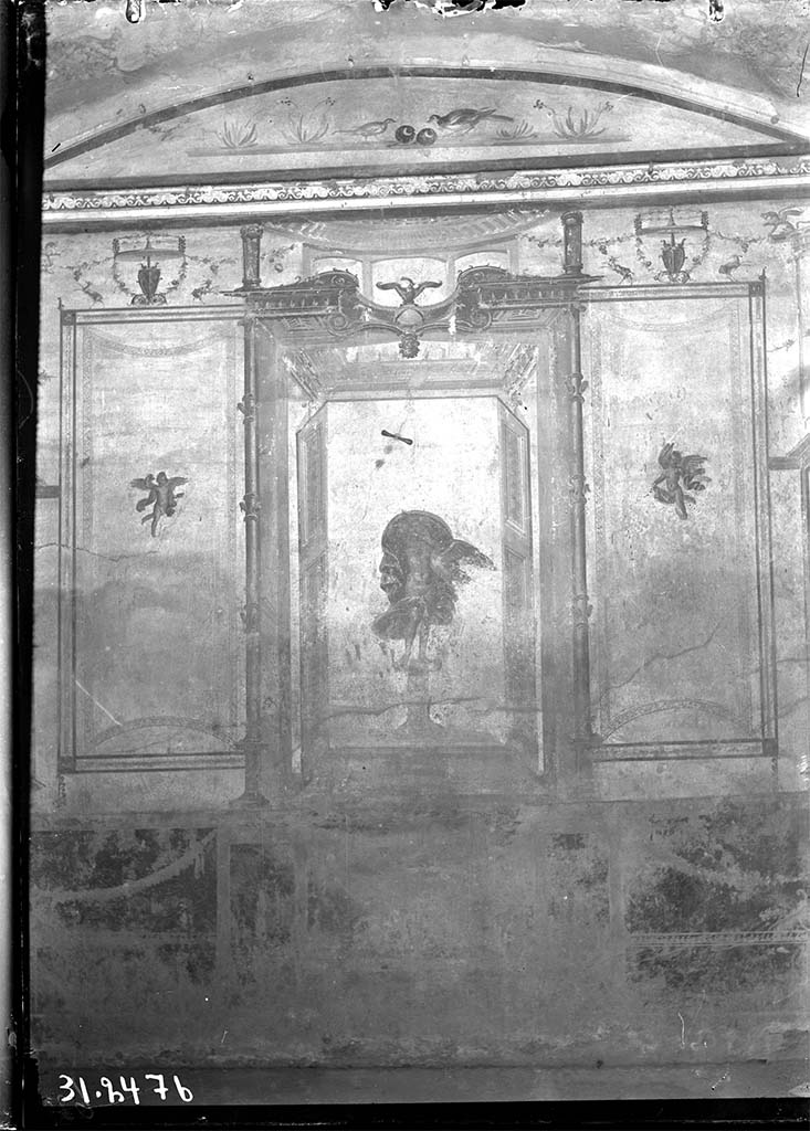 V.2.1 Pompeii. 1931? Room 8, looking towards west wall.
DAIR 31.2476 Photo � Deutsches Arch�ologisches Institut, Abteilung Rom, Arkiv. 
The zoccolo was red subdivided with panels with carpet borders and garlands.
In the centre was Leda and the Swan in an aedicula with doors at each side and with an eagle on a globe above.
In the side panels were carpet borders, curved on the short sides and with cupids in the centre of each panel and above were goats and garlands.
In the lunette above were birds with fruit and with flowers at the sides.
See Carratelli, G. P., 1990-2003. Pompei: Pitture e Mosaici: Vol. III. Roma: Istituto della enciclopedia italiana, p. 776-7.
