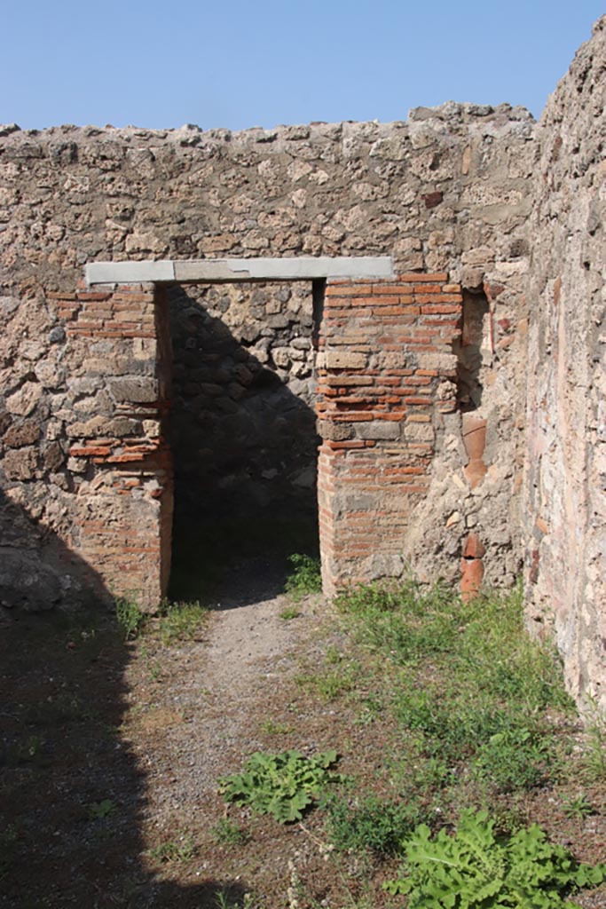 V.2.8 Pompeii. October 2023. 
Looking towards doorway in north wall of shop-room. Photo courtesy of Klaus Heese.
