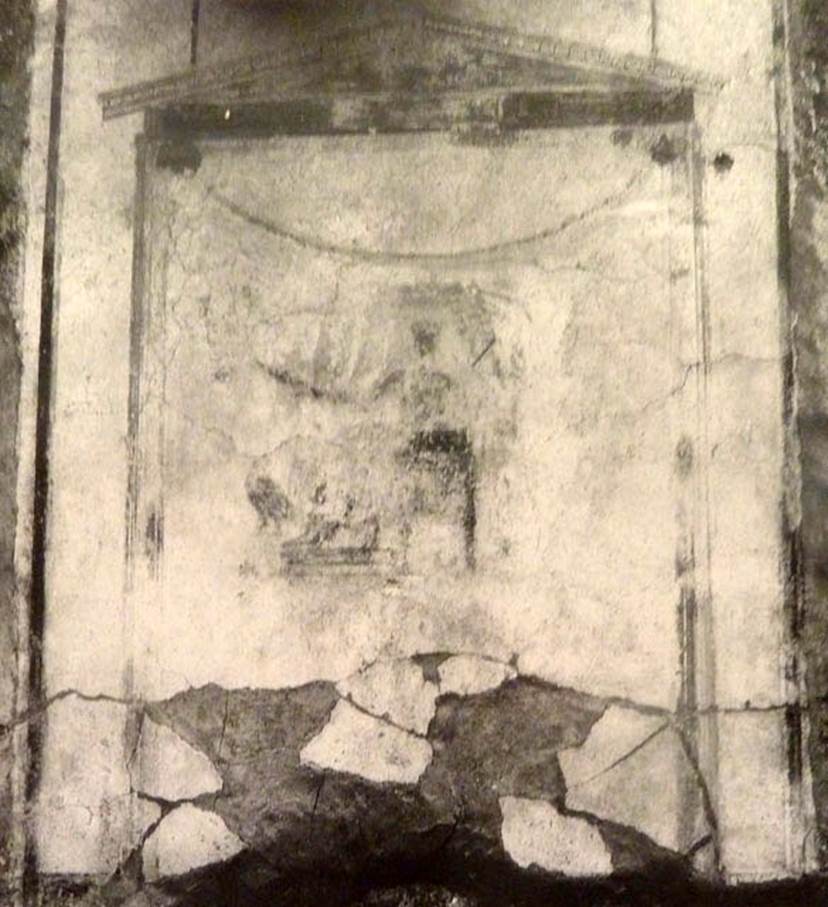 V.2.15 Pompeii. Old undated photograph. North wall of peristyle garden 11c. Remains of central painting in lararium.
Giove (Jupiter) sits on a throne, his lower body covered with a green robe.
The sceptre is in the left hand, leaning on the arm of the throne.
The lightning bolt is in his outstretched right hand and the eagle at his feet.
See Notizie degli Scavi di Antichità, 1894, p. 439.