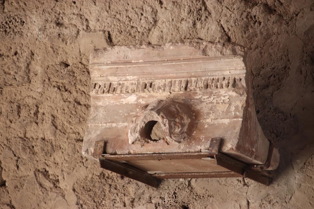 V.2.i Pompeii.  October 2023. Tablinum 7, waterspout on display against west wall. Photo courtesy of Klaus Heese.