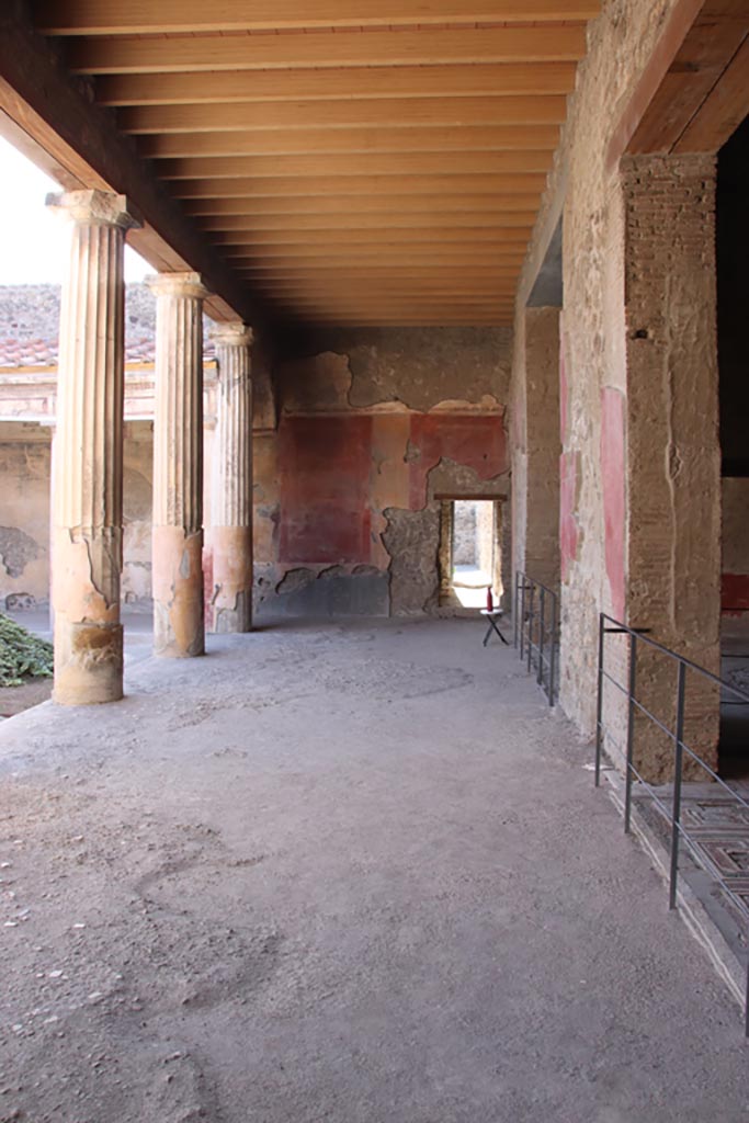 V.2.i Pompeii. October 2023. 
Looking west across north portico of peristyle towards doorway to room 11, kitchen.
Photo courtesy of Klaus Heese.
