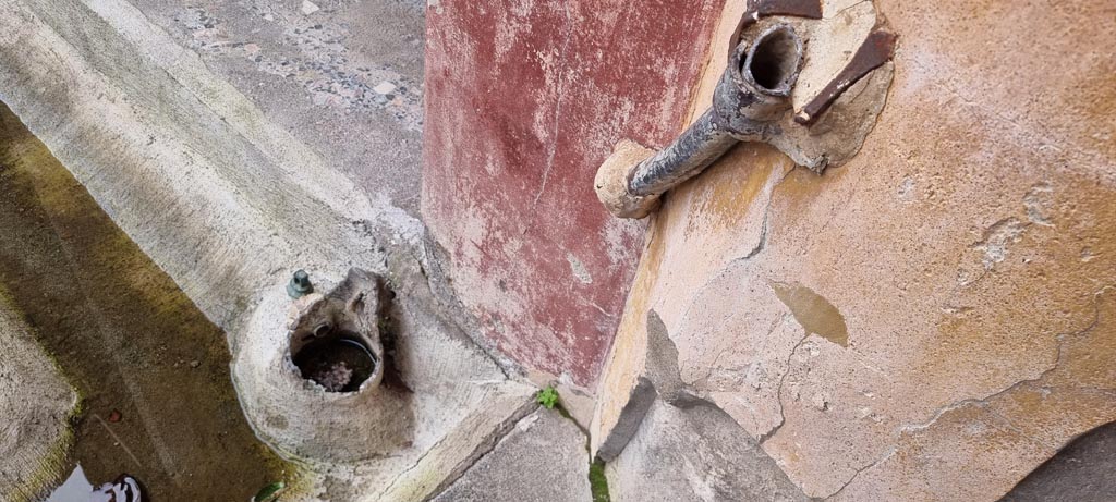 V.2.i Pompeii. December 2023. Room 23, detail of lead pipe work in north-west corner of peristyle. Photo courtesy of Miriam Colomer.

