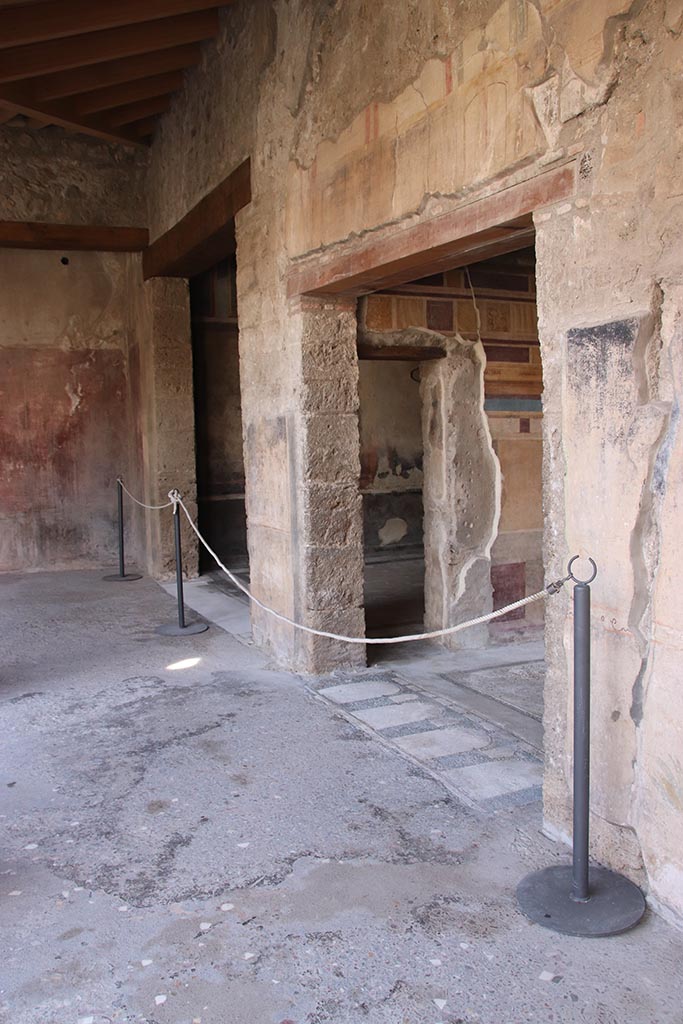V.2.i Pompeii. October 2024. Looking south along west wall of west portico.
Centre left is the doorway to room 17, with room 14, in centre with mosaic threshold.
Photo courtesy of Klaus Heese.
