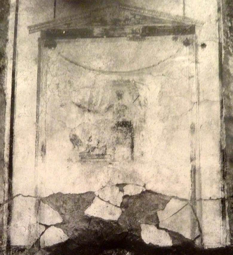 V.2 Pompeii. Casa di Orione. Old undated photograph.
North wall of peristyle garden 11c (A19). Remains of central painting in lararium.
Giove (Jupiter) sits on a throne, his lower body covered with a green robe.
The sceptre is in the left hand, leaning on the arm of the throne.
The lightning bolt is in his outstretched right hand and the eagle at his feet.
See Notizie degli Scavi di Antichità, 1894, p. 439.