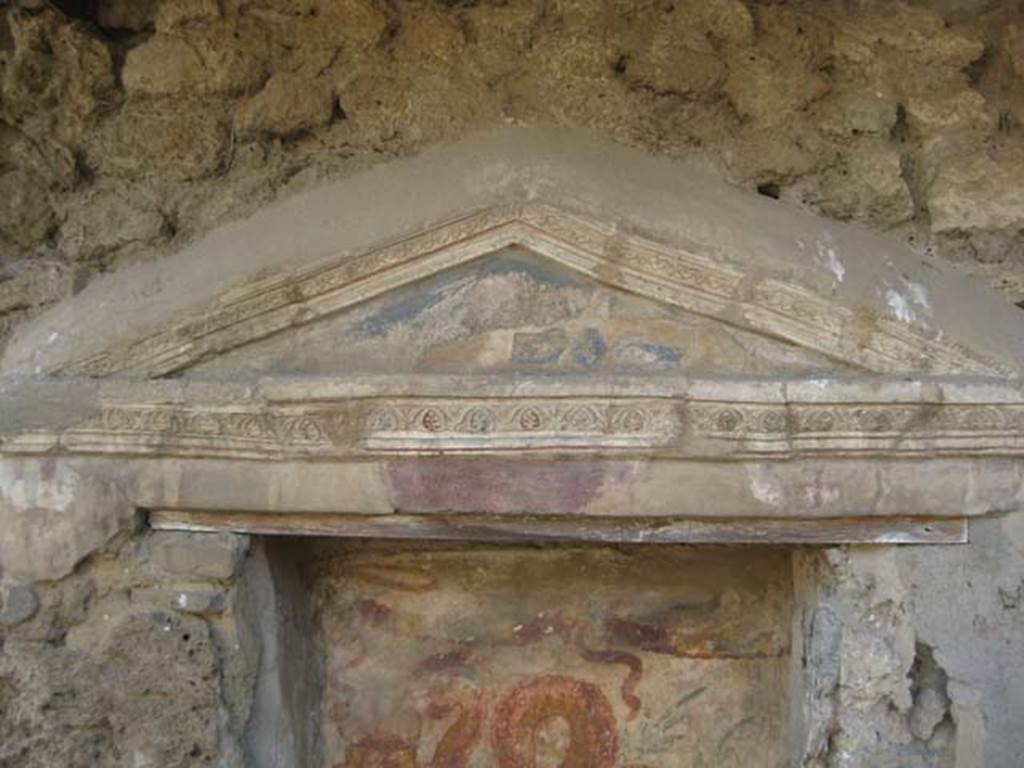 V.3.7 Pompeii. July 2012. Detail of aedicula lararium pediment, with blue tympanum and decorative stucco on west wall. Photo courtesy of Sharon M. Wolf.