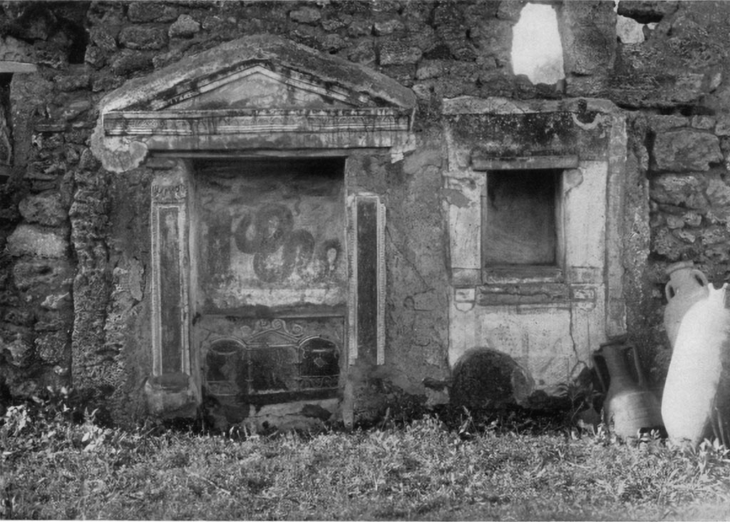 V.3.7 Pompeii. c.1930s. West wall of garden area. Large aedicula lararium and small niche on the right.
See Boyce G. K., 1937. Corpus of the Lararia of Pompeii. Rome: MAAR 14. (112, p. 38, Pl 36, 2).