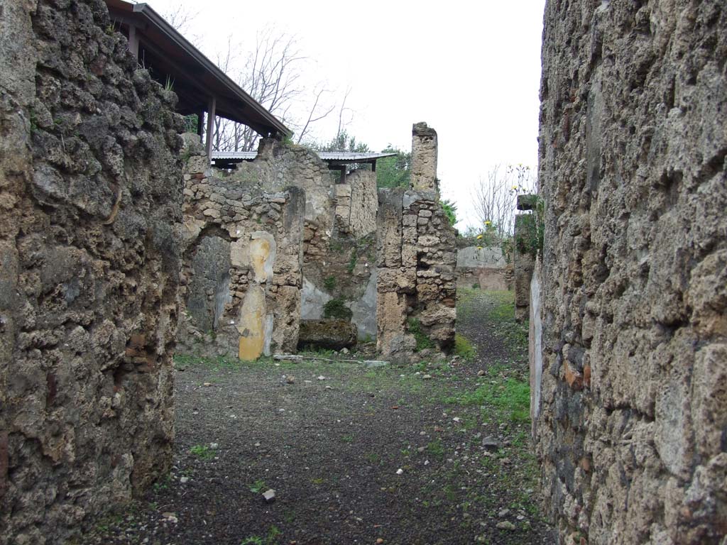 V.3.7 Pompeii. May 2010. 
Looking north from entrance fauces across atrium to doorway to triclinium and andron or corridor leading to garden.

