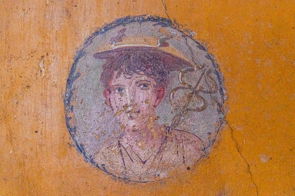 V.4.a Pompeii. October 2023.
Room ‘i’, wall painting of boy from west wall of cubiculum, on north side of doorway. Photo courtesy of Johannes Eber.