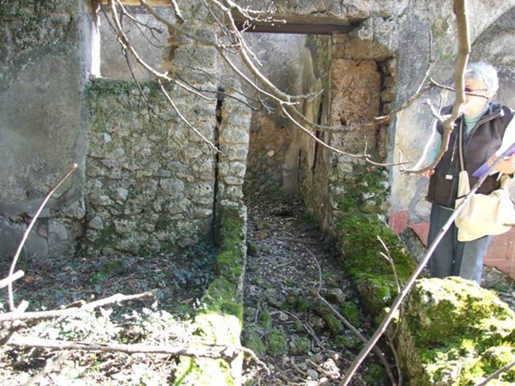 V.4.c Pompeii. March 2009.  Room K, looking south along west ambulatory. South wall of garden area, and window and doorway to kitchen, room M.
