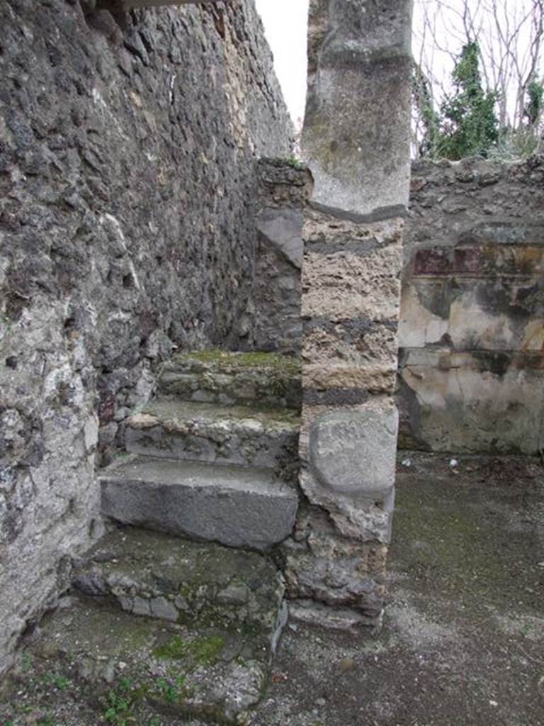 V.5.2 Pompeii. December 2007. Looking south to steps to upper floor in south-east corner of atrium. The doorway on the west side (right) of the steps led to a cubiculum �d�. The south wall, visible in the background, was decorated in the first style. These six masonry steps would have continued with wooden stairs. These steps and stairs would have been against the east wall and led above both cubiculum �d� and cubiculum �c�. See Notizie degli Scavi di Antichit�, 1895, p.150
