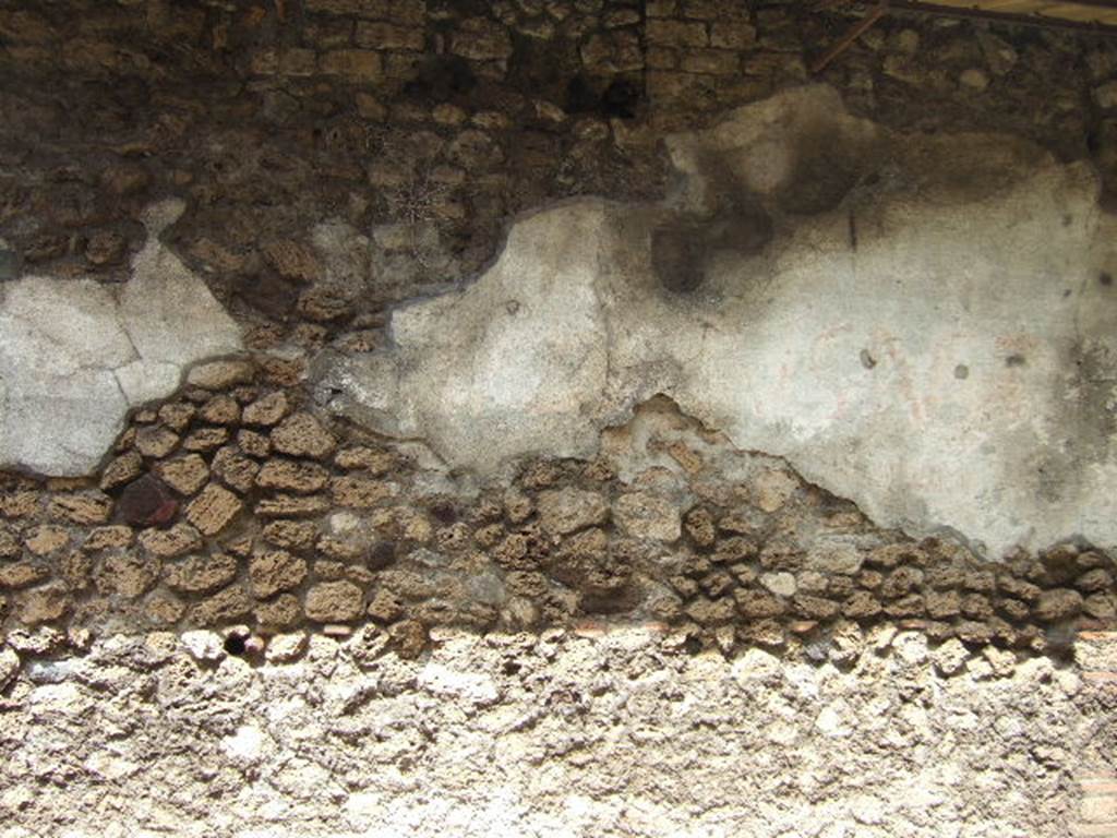 V.7.6 Pompeii. March 2009. West side of doorway, plaster on front wall.