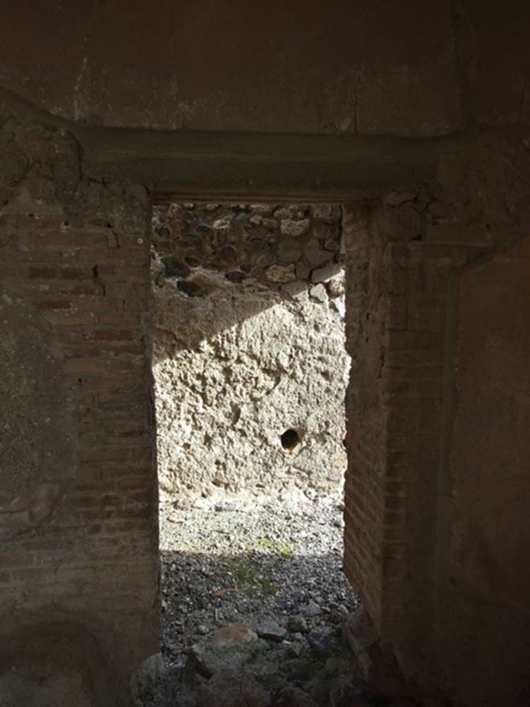 VI.1.7 Pompeii. December 2007. 
Doorway to room 24, services� room for the baths area, in south-east corner of portico.
In the east wall, one of the two conduits acting as vents from the adjacent praefurnium can be seen.

