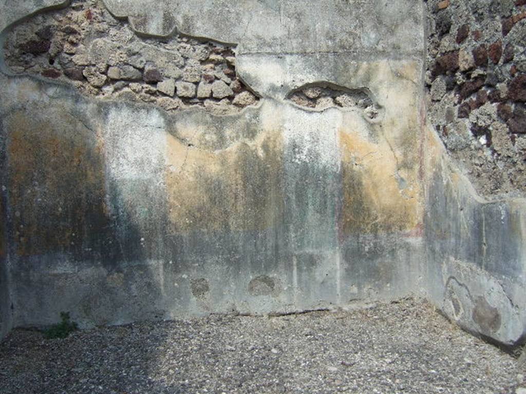 VI.2.16 Pompeii. September 2005. North wall of room on north side of peristyle. 
According to PPM �
�The north wall was preserved up until the curve of the vaulted ceiling, which was marked by a cornice of stucco, now lost. 
The wall was painted in the IV Style in a scheme with a symmetrical structure, with (yellow?) zoccolo subdivided into panels and compartments, and a yellow middle zone, with panels separated by architecture. 
Probably in this room the vignettes of Cupids, as drawn by Zahn, were to be found, (Helbig 649 and 699b). 
The upper zone of the wall was white.�
See Carratelli, G. P., 1990-2003. Pompei: Pitture e Mosaici. IV.  Roma: Istituto della enciclopedia italiana, p. 202.
See Zahn, W., 1828. Die sch�nsten Ornamente und merkw�rdigsten Gem�lde aus Pompeji, Herkulanum und Stabiae: I. Berlin: Reimer, taf. 74.
See Helbig, W., 1868. Wandgem�lde der vom Vesuv versch�tteten St�dte Campaniens. Leipzig: Breitkopf und H�rtel, (nos. 649 and 699b).
