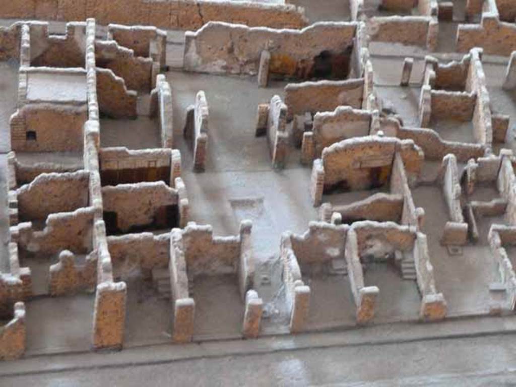 VI.3.7 Pompeii. May 2010. In the centre of the picture is a view, looking east from entrance corridor. From model in Naples Archaeological Museum.  According to Helbig, paintings found in the big room on the right from the garden (room in south-east corner on model above) were – Dido & Aeneas, (Helbig 1381) and Dido mourning, (Helbig 1381b)
See Helbig, W., 1868. Wandgemälde der vom Vesuv verschütteten Städte Campaniens. Leipzig: Breitkopf und Härtel. According to Fiorelli, the paintings found were the prophecy of Cassandra, and the abandonment of Dido. See Pappalardo, U., 2001. La Descrizione di Pompei per Giuseppe Fiorelli (1875). Napoli: Massa Editore. (p.52).   According to Breton, the house was discovered in January 1806 and was given its name by the number of painted musical instruments found on the atrium walls. On the right (south) of the atrium were two rooms (according to Fiorelli, “the atrium was bordered by four cubicula” presumably two on either side) then instead of an ala an open room with a bath, having at the rear a baptisterium in which one descended by two steps, as one has seen in the Baths, but here it was in stone, paved with bricks and covered in stucco. (According to Fiorelli “ and an ala where others have recognised a bath, but to me it seems footings for a wooden cupboard”) To the left was a large triclinium. The tablinum was placed between two corridors and entirely open, front to back. The peristyle was small, having a portico on the side near the tablinum, which was supported by a masonry pillar. In the corridor on the right of the tablinum was the entry to the kitchen. This corridor lead directly into an oecus, where some paintings were still conserved - Dido learning of the departure of Aeneas and, nearly vanished, a religious scene. At the back of the peristyle one saw a small altar discovered 24th March 1810, surmounted by the two serpents and a painting of the genius making a libation. This painting had nearly vanished. See Breton, Ernest. 1870. Pompeia, Guide de visite a Pompei, 3rd ed. Paris, Guerin. Photos taken from the rear entrance, of the rear rooms can be seen at VI.3.25 and VI.3.26.
