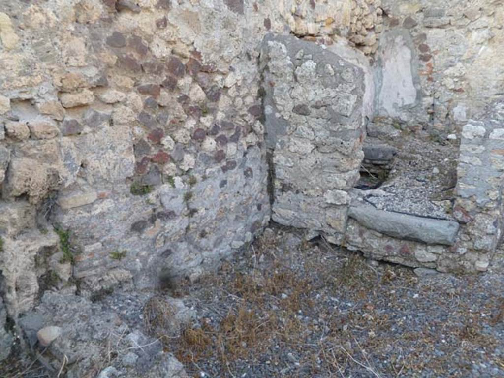 VI.5.9 Pompeii. May 2011. Doorway to latrine/small room in north-east corner of kitchen area.
According to Hobson, �As a result of the lack of preservation of wood in Pompeii, no doors have been found for latrines. 
However, a large percentage of latrine rooms have threshold stones which may have grooves into which door posts were set. 
Many of the rooms have a step up from the floor of the corridor or outer room. 
This not only serves to differentiate the cubicle from other rooms, but also allows for the tile system to drain efficiently under the toilet seat.�
See Hobson, B., 2009. Latrinae et foricae: Toilets in the Roman World. London; Duckworth. (p.82 and fig.105, showing grooves for doorposts).
