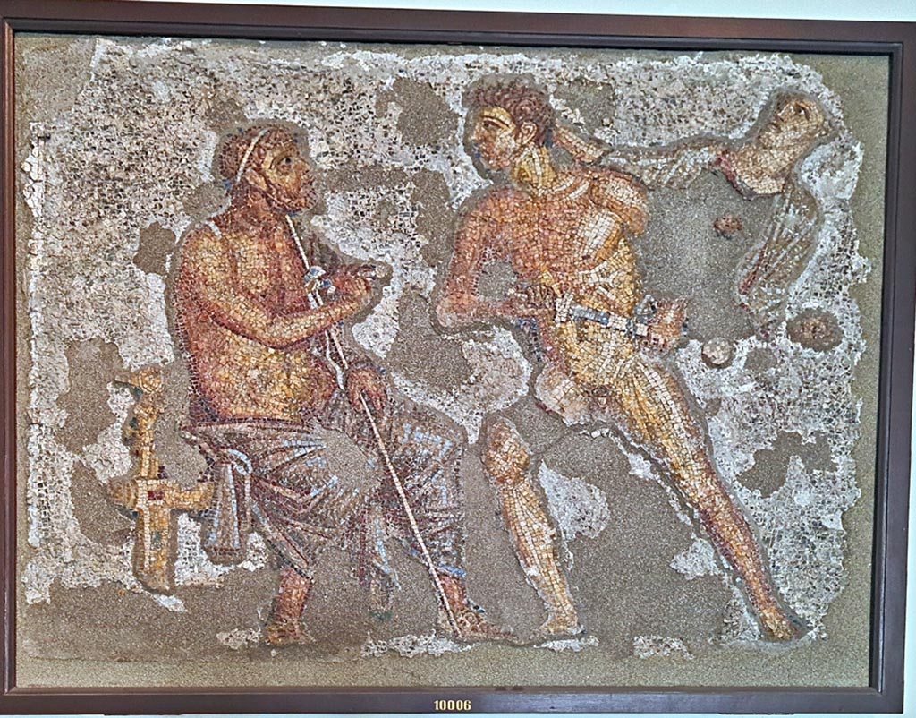 VI.7.23 Pompeii. September 2024.South side of garden portico. Mosaic of Achilles confronting Agamemnon.
Now in Naples Archaeological Museum. Inventory number 10006. Photo courtesy of Giuseppe Ciaramella.
According to the information card –
Achilles confronts Agamemnon. Polychrome wall mosaic made of limestone, glass paste and shells.
Achilles, restrained by Athena, in his attempt to have Brisels returned to him, unsheathes his sword and approaches Agamemnon who is seated on a stool and looks startled. To the right, his beloved slave girl observes the scene in dismay.
(Third quarter of the Ist century AD.)
(Achille affronta Agamennone. Mosaico parietale policromo in calcare, pasta vitrea e conchiglia.
Achille, trattenuto da Atena, per ottenere la restituzione di Briseide, sguaina la spada contro Agamennone, seduto su un sgabello e sorpreso.
A destra, l’amata schiava osserva sconvolta la scena. Terzo quarto del I secolo d.C.)