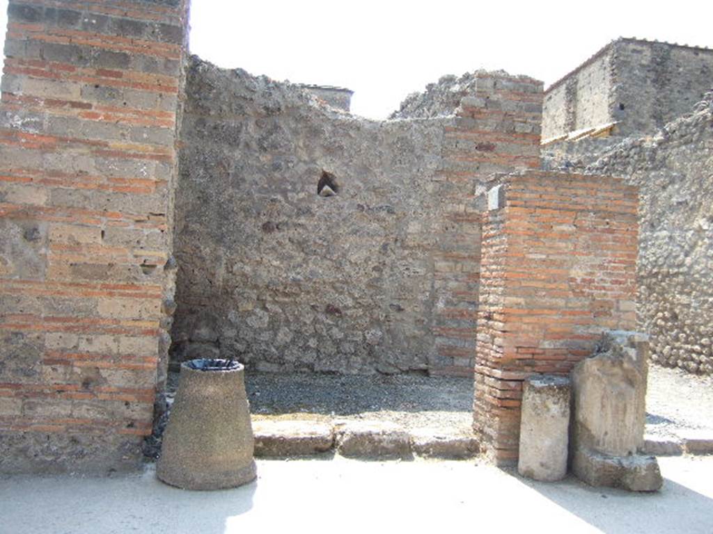 VI.8.12 Pompeii. May 2006. Looking west to entrance doorway.
According to Della Corte, on the left of entrance number 12 was found an electoral recommendation from the Pomari (the fruitsellers)�
Pomari rog(ant) [CIL IV 180].
Between the entrances of VI.8.12 and 13 was found �
Pomari facite     [CIL IV 183], and then opposite this third, was found �
Pomari rog(ant)    [CIL IV 149]
A fourth recommendation could be read on the exterior of the House of Helvio Vestale (VI.8.22/1)�
Pomari rog(ant)    [CIL IV 206]      and also near this last was found �
Pomari universi
Cum Helvio Vestale rog(ant)    [CIL IV 202]
Della Corte�s theory was that this all proved that Helvius Vestalis was the protector, the head of the collegium of fruitsellers of Pompeii, and that the meetings of the society were perhaps held in the upper rooms of number 12 and 13.  See Della Corte, M., 1965.  Case ed Abitanti di Pompei. Napoli: Fausto Fiorentino. (p.59)
According to Epigraphik-Datenbank Clauss/Slaby (See www.manfredclauss.de), these read as �
M(arcum) Enium Sabinum 
aed(ilem) pomari rog(ant)      [CIL IV 180]
Vettium Firmum
aed(ilem) o(ro) v(os) f(aciatis) dign(um)
est pomari facite                      [CIL IV 183]
M(arcum) Cerrinium
aed(ilem) pomari rog(ant)      [CIL IV 149]
M(arcum) Holconium
Priscum aed(ilem) pomari rog(ant)      [CIL IV 206]
M(arcum) Holconium
Priscum IIvir(um) i(ure) d(icundo)
pomari universi
cum Helvio Vestale rog(ant)     [CIL IV 202]
According to Pagano and Prisciandaro, found in July 1825 written on the wall on the left, was �
Marcellum aediles
et Albucium
o(ro) v(os) f(aciatis)    [CIL IV 182]
and in September 1825, found written in red, were �
Faustinium    [CIL IV 185]
L(ucium) Albucium    [CIL IV 186]
and in February 1826, found painted in red, on the pilaster between 12 and 13, was �
M(arcum) Albucium aed(ilem)    [CIL IV 184]
See Pagano, M. and Prisciandaro, R., 2006. Studio sulle provenienze degli oggetti rinvenuti negli scavi borbonici del regno di Napoli.  Naples : Nicola Longobardi. (p. 133-4)   PAH II, 135,  PAH II, 148.
