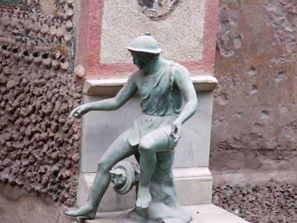 VI.8.23 Pompeii. May 2010. Bronze statue of fisherman.
According to Wilhelmina, the figure was seated on a tree stump and from the position of his hand was thought to be holding a fishing rod.
On the tree stump was a mask, which would have been used as a fountain jet, but was not in use.
See Jashemski, W. F., 1993. The Gardens of Pompeii, Volume II: Appendices. New York: Caratzas. (p.136)
