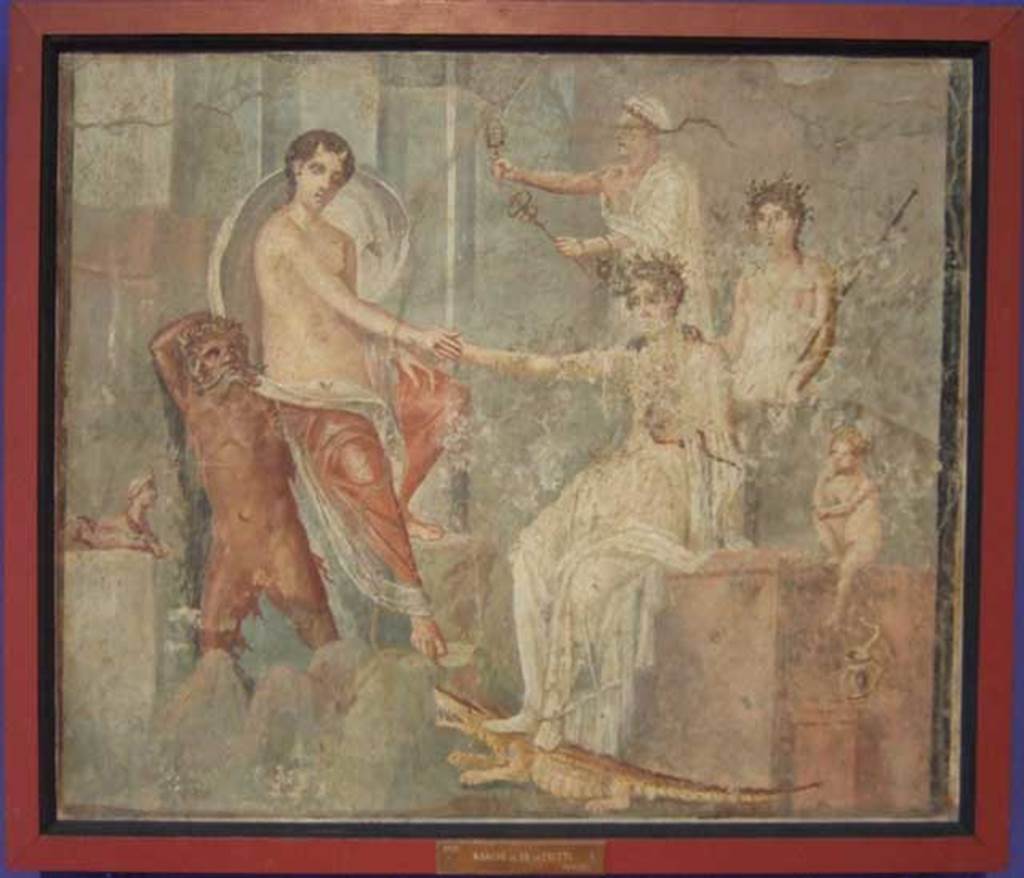 VI.9.1 Pompeii. Painting of the Arrival of Io at Canopus. From a room north of the atrium. 
Io is depoasited on the rocks at Canopus carried by a river god, probably the Nile. She is being greeted by Isis. Behind Isis stand two figures, possibly Mercury and a priest. The small Harpocrates is to the right of the painting with his hand to his lips in the gesture of silence. To the left of the river god is a sphinx, and under Isis foot is a crocodile and a cobra. Now in Naples Archaeological Museum. Inventory number 9555. The house was named after this painting. See Zahn in BdI 1831 p. 18. See Helbig, W., 1868. Wandgem�lde der vom Vesuv versch�tteten St�dte Campaniens. Leipzig: Breitkopf und H�rtel. (139).