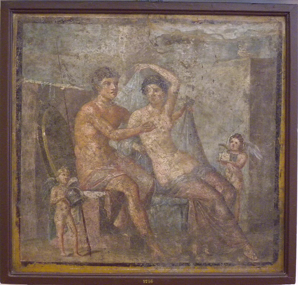 VI.9.2 Pompeii. Found 30th October 1829 in room 8, tablinum from south wall.
Wall painting of Mars and Venus with two cupids who hold the god’s helmet and the goddess’ box.
Now in Naples Archaeological Museum. Inventory number 9256.
See Helbig, W., 1868. Wandgemälde der vom Vesuv verschütteten Städte Campaniens. Leipzig: Breitkopf und Härtel. (318).
