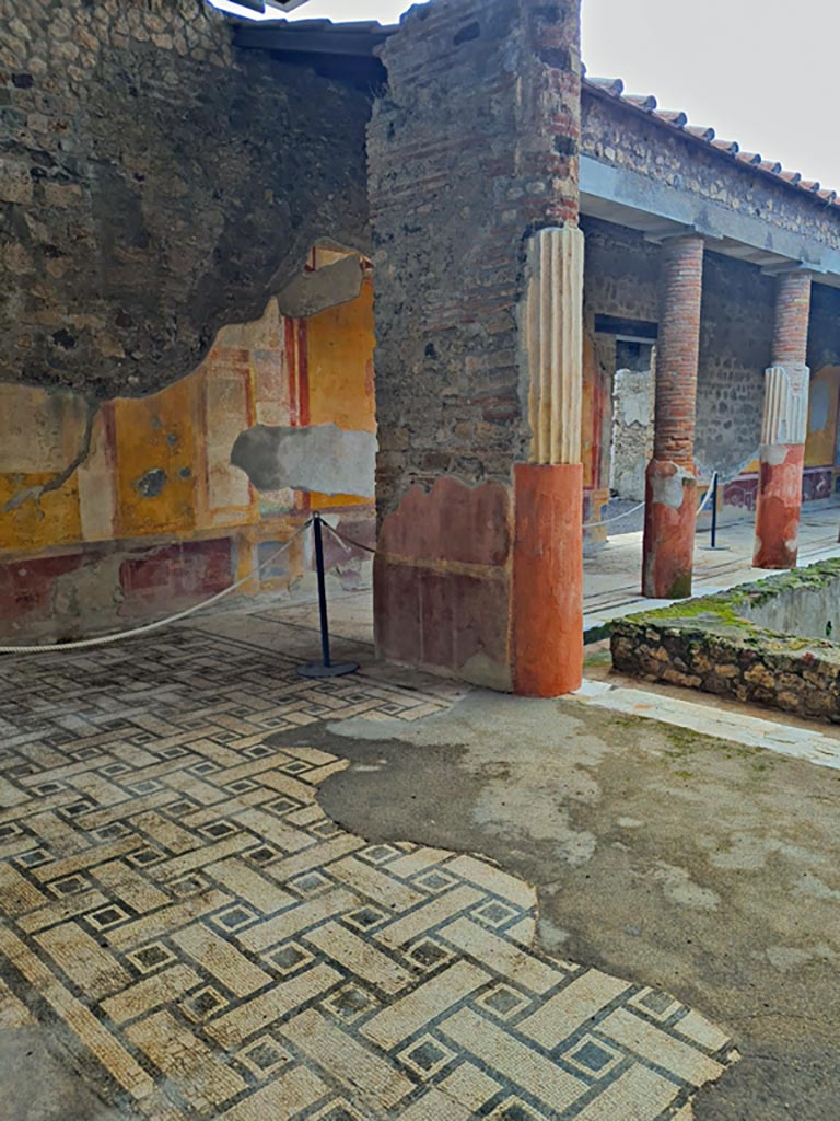 VI.9.6 Pompeii. November 2023.
Room 6, looking south-west across east portico towards pilaster. Photo courtesy of Giuseppe Ciaramella.