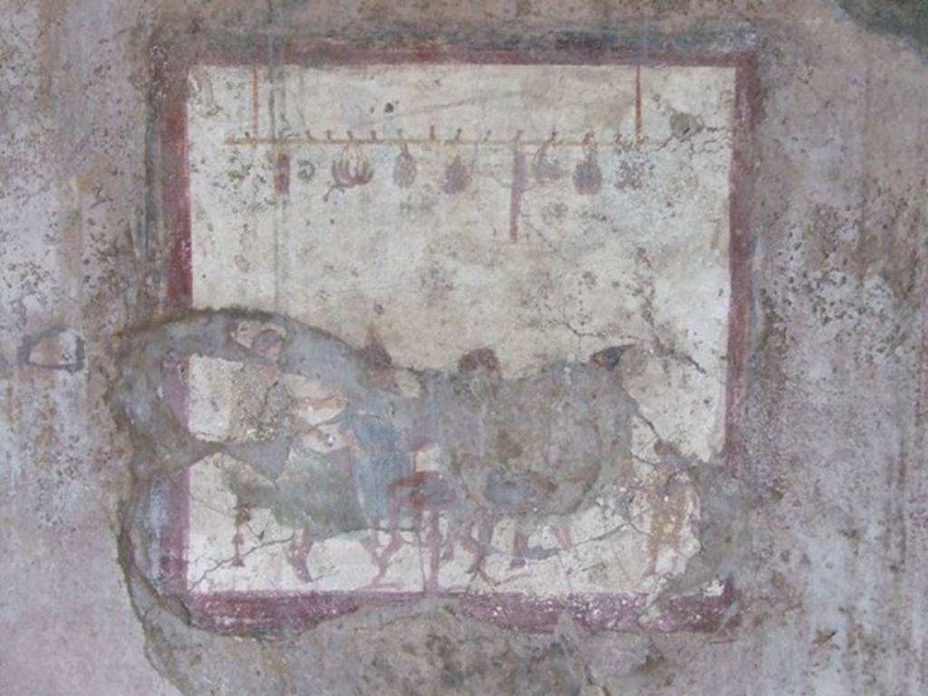 VI.10.1 Pompeii. March 2009. Fresco on south wall of rear room on north side.  People at a table with sausages, onions and other food hanging above them.
