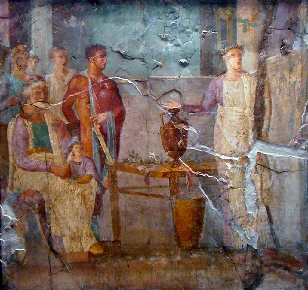 VI.10.2 Pompeii.
Wall painting of Aeneas consulting Anio or the Vaticinio di Cassandra. This painting was also found in the oecus.
Now in Naples Archaeological Museum. Inventory number 8999.
According to PAH, this is Aeneas consulting Anio, the King of Ortigia, accompanied by Anchises and the little Ascanius.
See PAH II, p. 219, March 1829.
According to Coarelli and Pesando, this is Cassandra prophesising the fall of Troy.
Priam is sitting, with the young Paris leaning on his thigh. Hector is next to them, holding a dagger that is resting on a table.
Cassandra is on the right of the picture, with her hand outstretched.
See similar paintings in I.2.28 and VI.3.7.
See Coarelli F. and Pesando F. et al, 2006. Rileggere Pompei: l’insula 10 della regione VI. Roma: L’Erma di Bretschneider. p. 60-1, Tav. XVII.
Our thanks to Rachel Lowder for helping with this.