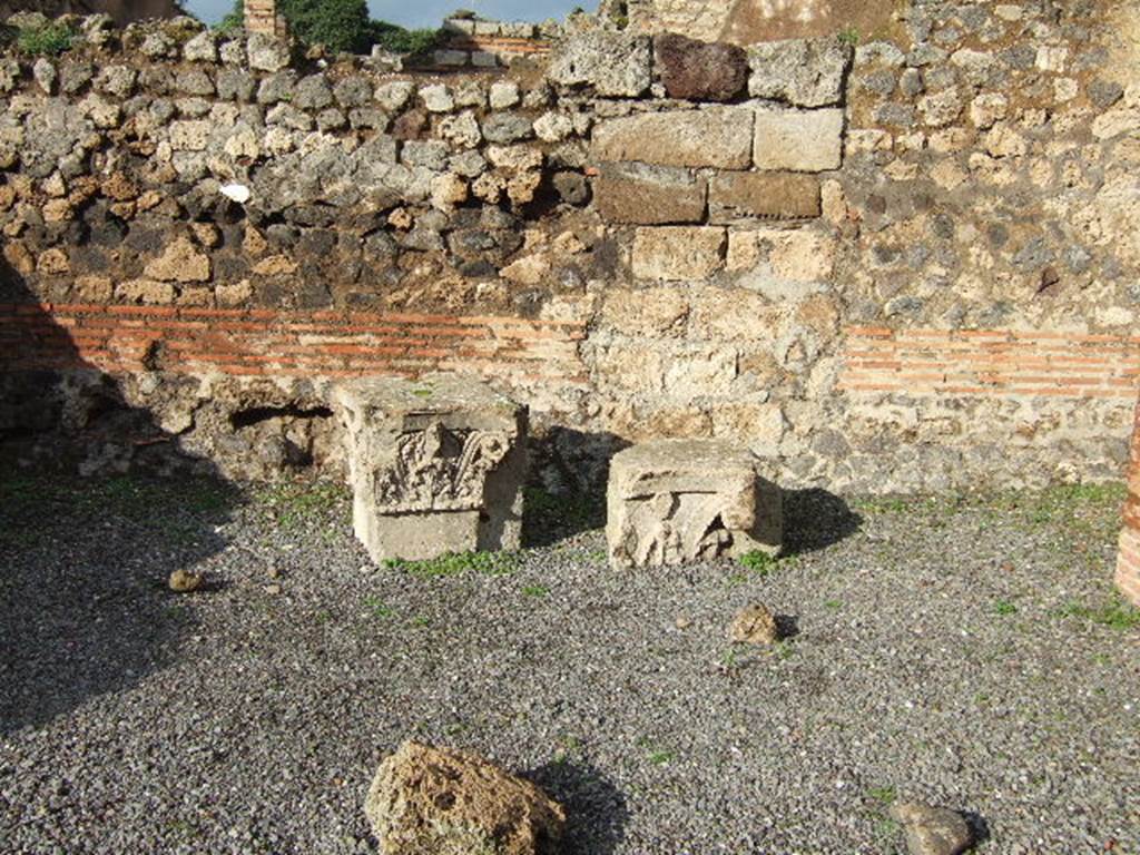 VI.10.15 Pompeii. December 2005. Two tufa capitals. These capitals were lodged here for safety, they most probably topped the pilasters of the vestibule of VI.10.14.
See Studi della Soprintendenza archeologica di Pompei, 12, (2006): Rileggere Pompei, I. L�insula 10 della Regio VI, ed by Coarelli and Pesando, Rome, �L�Erma� di Bretschneider, (p.345)
