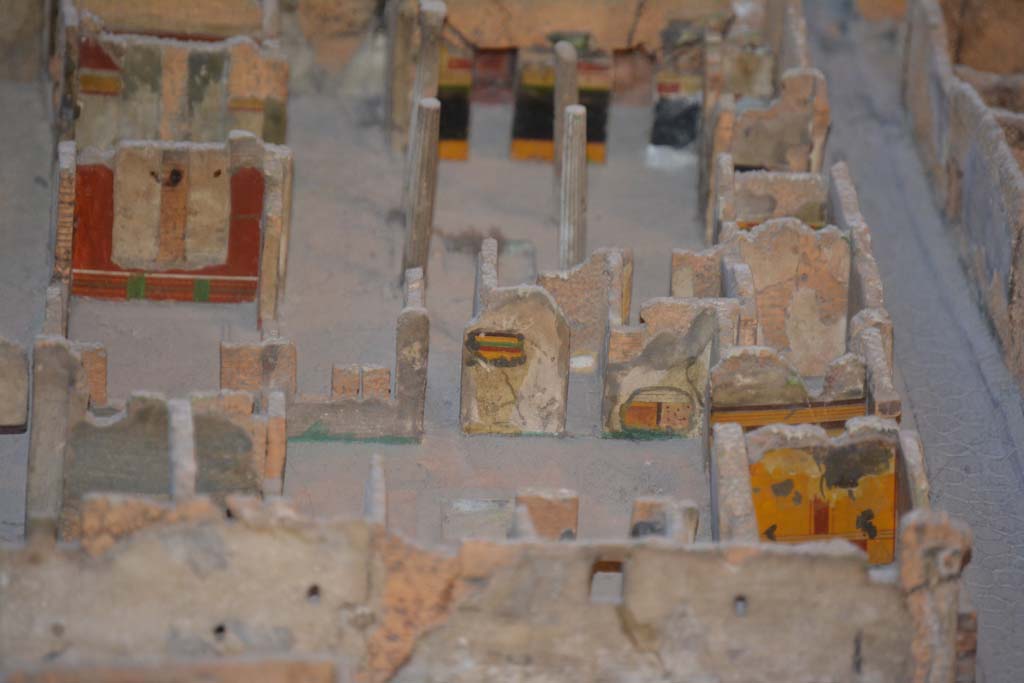 VI.11.9/10 Pompeii. July 2017. Looking east with atrium 3 in centre, and atrium 27, above it.
In the east wall of atrium 3, the yellow/green/red striped upper wall between corridor 48, and room 29, can be seen as well as the painted lower wall in south-east corner. 
The yellow wall (next to Vicolo di Mercurio) is the east wall of room 5.
On the left side of the photo is the red east wall of room 35.
At the rear of room 35 is the east wall of tablinum 33.
In the upper centre is the black/yellow wall of the east wall of atrium 27.
From cork model in Naples Archaeological Museum.
Foto Annette Haug, ERC Grant 681269 D�COR.
