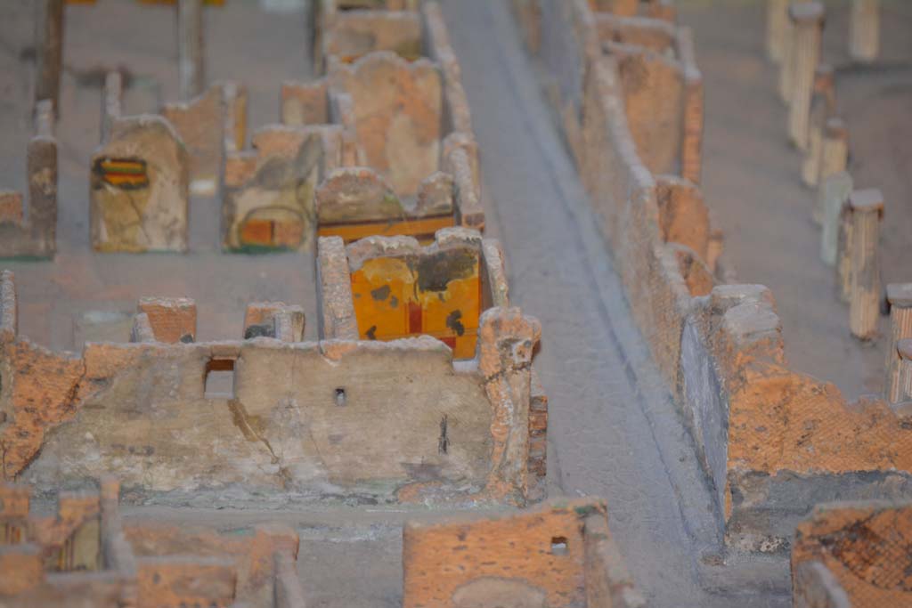 VI.11.9/10 Pompeii. July 2017. Looking east from junction of (lower) Vicolo del Fauno and Vicolo del Mercurio, centre right.
The yellow wall (next to Vicolo di Mercurio) is the east wall of room 5.
From cork model in Naples Archaeological Museum.
Foto Annette Haug, ERC Grant 681269 D�COR.
