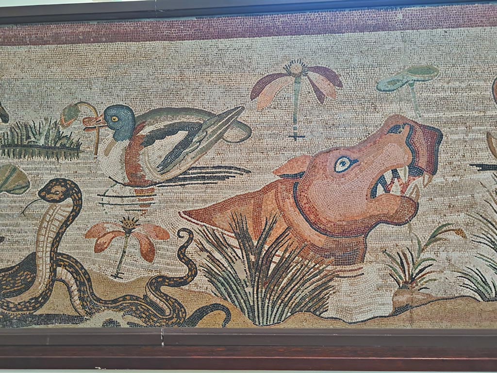 VI.12.2 Pompeii. September 2024. 
Detail from mosaic of Nilotic scene, including ducks, cobra and hippopotamus. Photo courtesy of Giuseppe Ciaramella.
