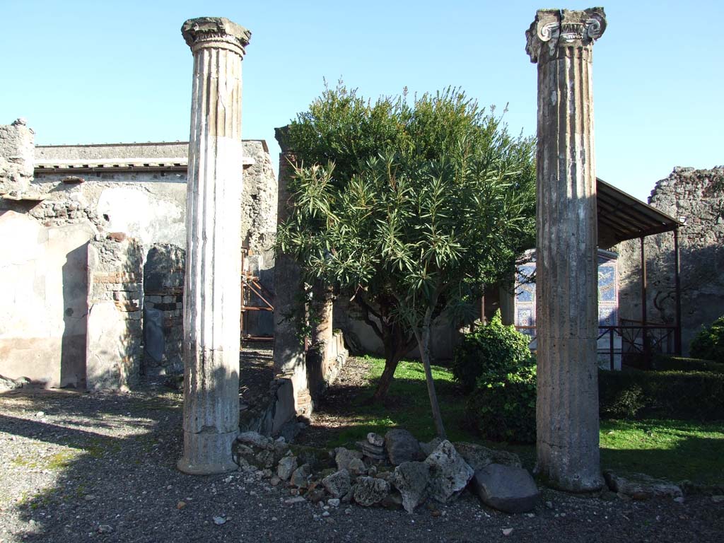 VI.14.43 Pompeii. December 2007. North-west corner of the peristyle, with corridor to rooms at rear of the house on the north side, on left.
According to Jashemski, the portico was supported by four fluted columns joined by a low wall.
See Jashemski, W. F., 1993. The Gardens of Pompeii, Volume II: Appendices. New York: Caratzas. (p.151)