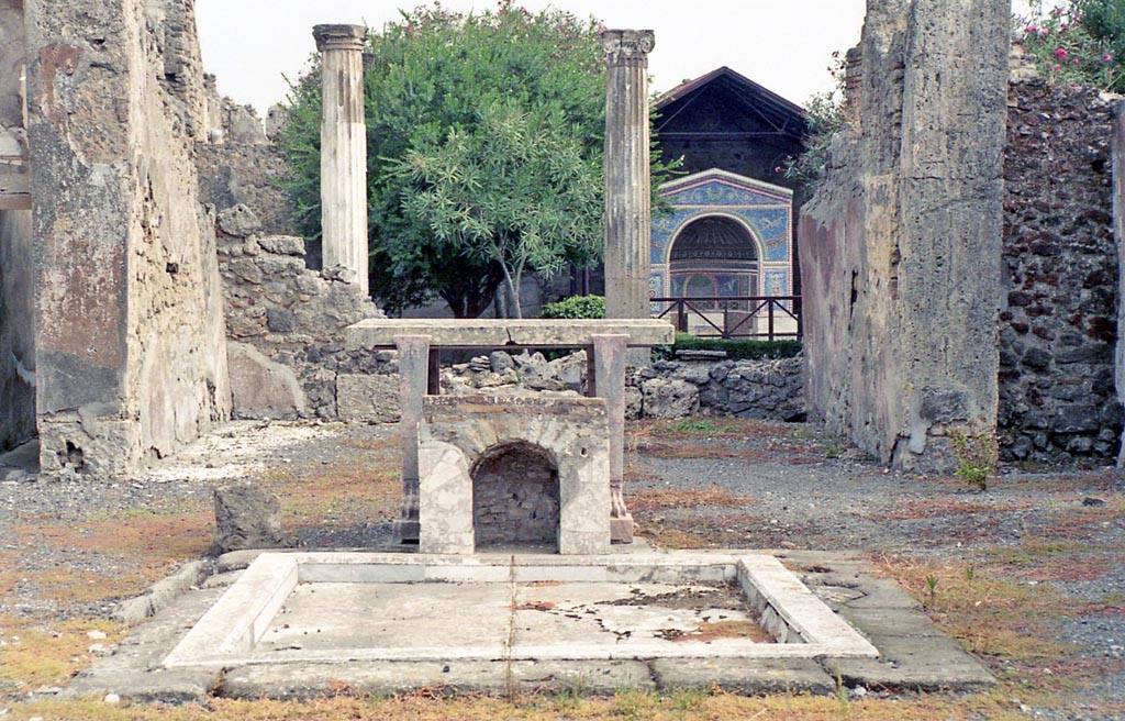 VI.14.43 Pompeii. October 2001. 
Room 1, looking east across impluvium in atrium, towards tablinum, and garden area. Photo courtesy of Peter Woods.

