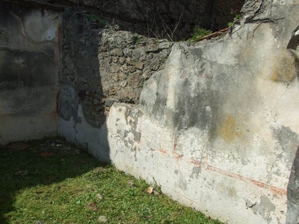 VI.15.5 Pompeii. March 2009. Room 22, north wall. According to NdS, in a panel on the north wall was a partly preserved figure of a flying Nike. The painting was damaged at the top and on the right side. In the left a round dish bearing a palm leaf was held out, and in the right a yellow jar was being lowered, pouring out liquid.
In a panel on the east wall, Sogliano could see a male figure(?) with a short tunic. In his lowered right hand he held a �simpulum�, ( a long handled ladle) and in his stretched out left hand, a �kantharos�.(a wine cup with high handles). In the other panels were a tiger, a swan, a flying griffin, a dolphin, etc.
