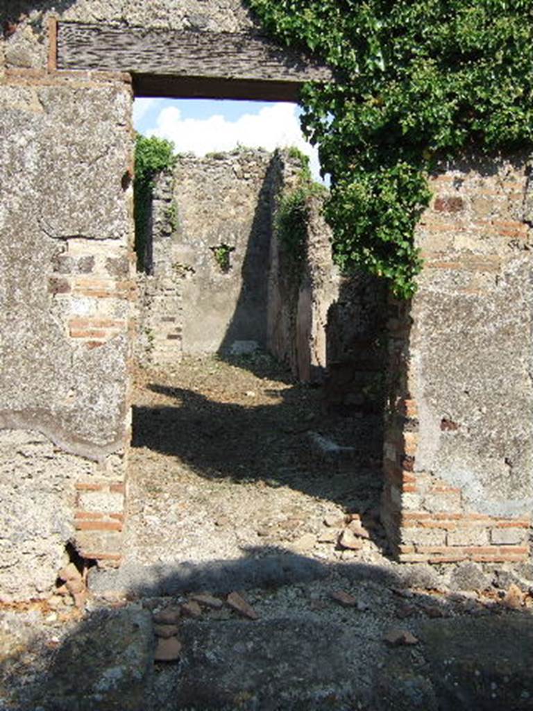 VI.15.22 Pompeii. September 2005. Looking east towards entrance doorway. According to Della Corte, the name on an amphora with its contents which was found here, was �
Cinnio Fortunato.  
See Della Corte, M., 1965.  Case ed Abitanti di Pompei. Napoli: Fausto Fiorentino. (p.62)
According to Epigraphik-Datenbank Clauss/Slaby (See www.manfredclauss.de), it read -
Lac bes lixa vet(us) 
summa(rum) 
AAA 
CXL 
C(ai) Terenti Paul(li) 
/ 
Cinnui fort 
/ 
LXXXIV s(emissem)       [CIL IV 5648]

