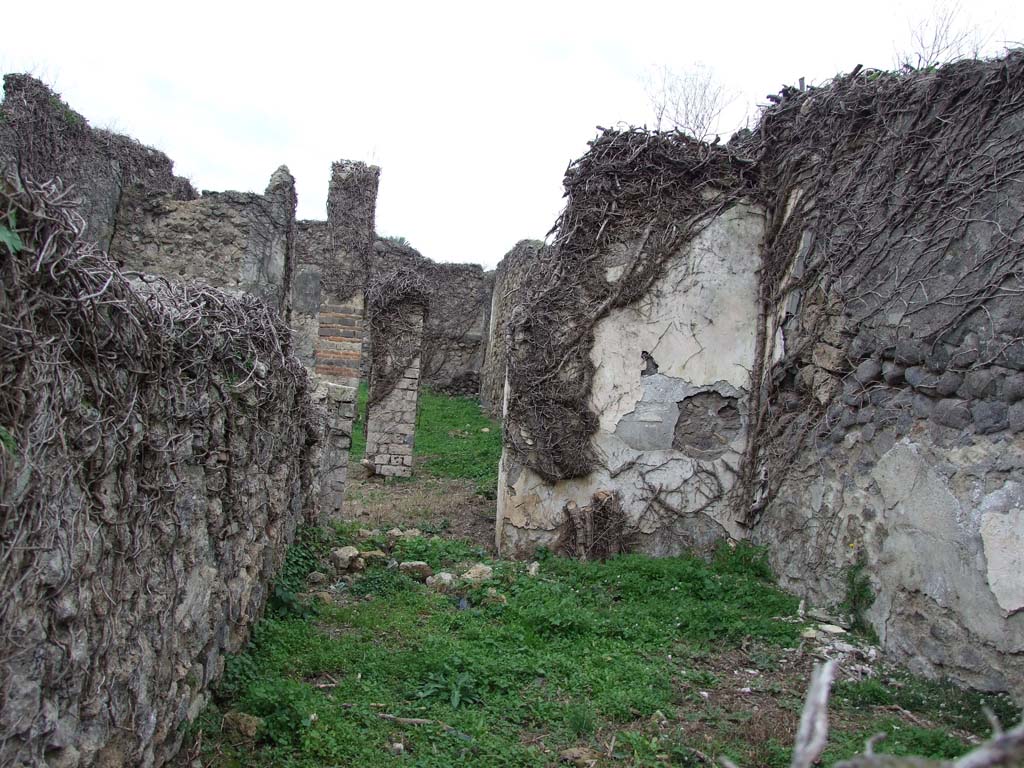 VI.16.10 Pompeii. December 2007. Triclinium, or cubiculum, in north-east corner of house.
According to Eschebach this was the triclinium.
According to NdS, this was another cubiculum D, described as being to the east of the corridor B.
It was entered through white doorposts, and originally would have had a wooden threshold, that formed a descending step.
The floor was of concrete and the white walls had a dado formed by decorations limited by red bands and in which were other small decorations with yellow bands.
