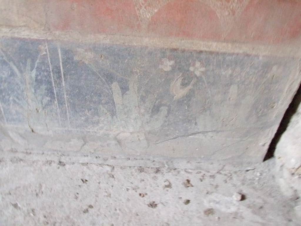 VI.16.15 Pompeii. December 2006. South end of base of east wall of room F with detail of wall painting of plants.