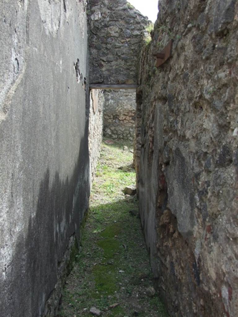 VI.16.27 Pompeii. March 2009. Corridor leading south towards rooms Y, Z and A�. According to NdS, this corridor ran south behind the west side of the peristyle. Its walls were similarly painted to the fauces, imitating slabs of marble with black and white vertical streaks.
