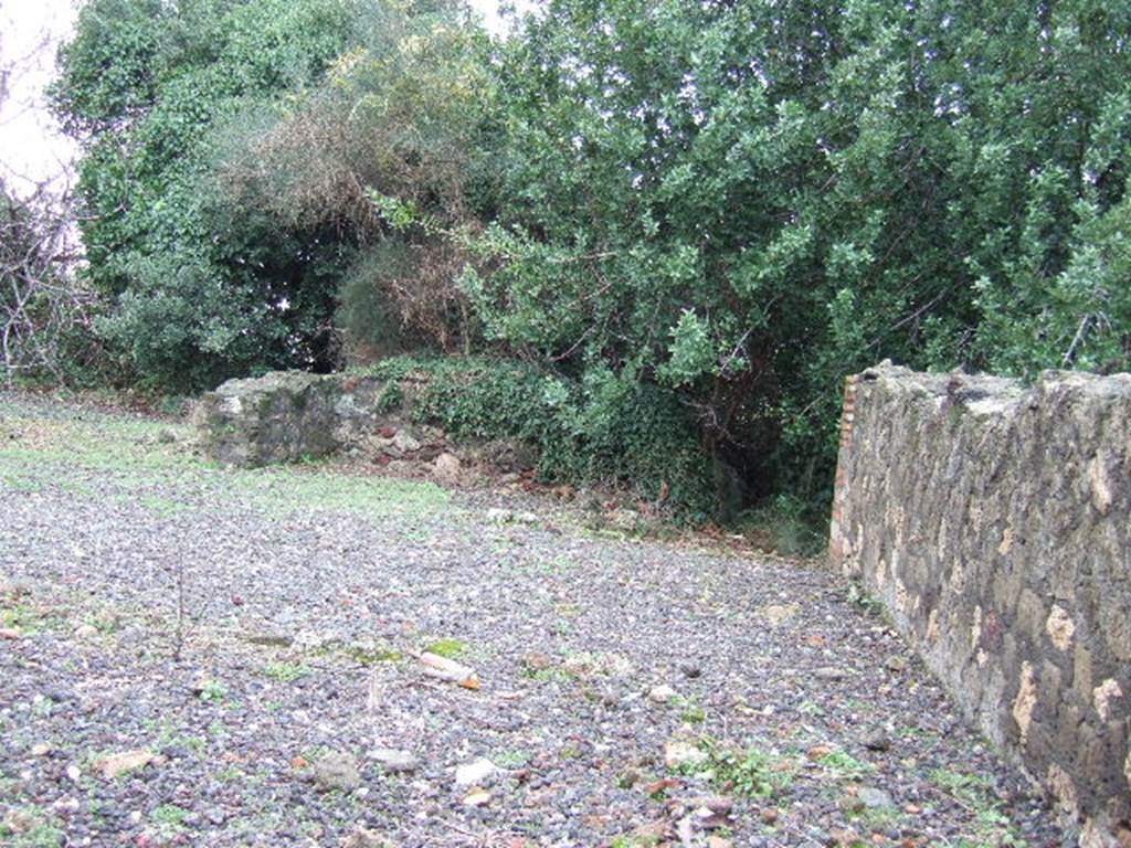 VI.17.9 Pompeii. December 2005. Looking west across remains of three rooms on north side of atrium of VI.17.10 and towards a corridor to ruined rear rooms (blocked). According to Garcia y Garcia, due to the 1943 bombing, a part of the floor of the atrium and three dividing walls of the rooms on the north side of the atrium of VI.17.10 were destroyed.
See Garcia y Garcia, L., 2006. Danni di guerra a Pompei. Rome: L�Erma di Bretschneider. (p.96)
According to Jashemski- 
She said that Zahn stated that this house was in a ruined state at the time of its excavation (1775-80). See Jashemski, W. F., 1993. The Gardens of Pompeii, Volume II: Appendices. New York: Caratzas. (p.165). 

