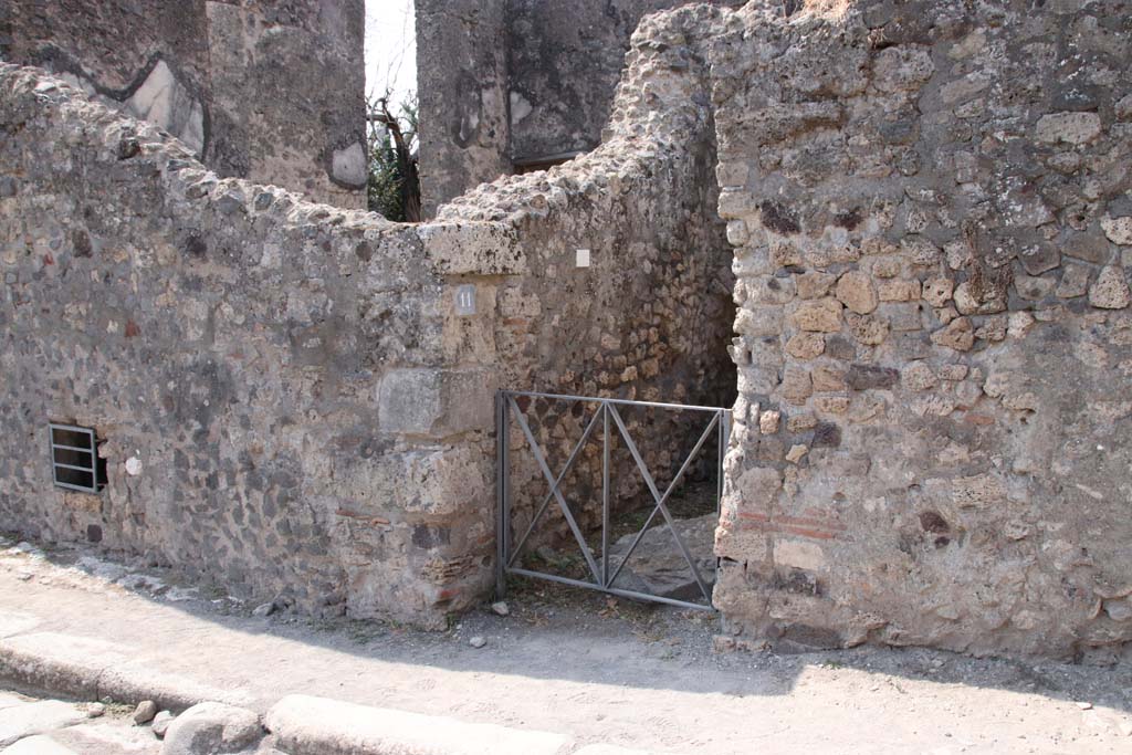 VI.17.11 Pompeii. September 2021. Looking south-west towards entrance on Via Consolare. Photo courtesy of Klaus Heese.
On the left of the entrance would be the underground area of VI.17.12, with the triclinium of VI.17.13, above it.
See comment in VI.17.13, repeated below -
According to Allroggen-Bedel, she could not locate rooms 11 and 12 of VI.17.10, but, she wrote -
�However two rooms in the next door house (VI.17.12-13) meet the description of rooms nos. 11 and 12.
La Vega said that in the space described as no.12, he had discovered a �sotterraneo� (underground room/cellar, etc). 
The characteristics of the rooms� bed recess and sotterraneo, were both to be found next to the cellar stairs in VI.17.12.
The room described as no.11 is probably identical with the room next door (VI.17.13), where the remains of the yellow background central zone decorations  were preserved.�
See Allroggen-Bedel - Die malereien aus dem Haus Insula Occidentalis 10, in Cronache Pompeiane II, 1976 (p.144-183).
