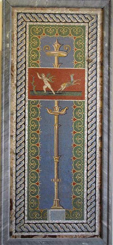 VI.17.36 Pompeii? One of two panels with candelabra, cupid and deer.
Now in Naples Archaeological Museum. Inventory number 10013.
The museum card says it was found in VI.17.36.
According to Prisciandaro and Pagano, it was found on 30th April 1752 in the Villa San Marco at Stabia together with other mosaics.
See Pagano, M. and Prisciandaro, R., 2006. Studio sulle provenienze degli oggetti rinvenuti negli scavi borbonici del regno di Napoli. Naples: Nicola Longobardi, p. 239.