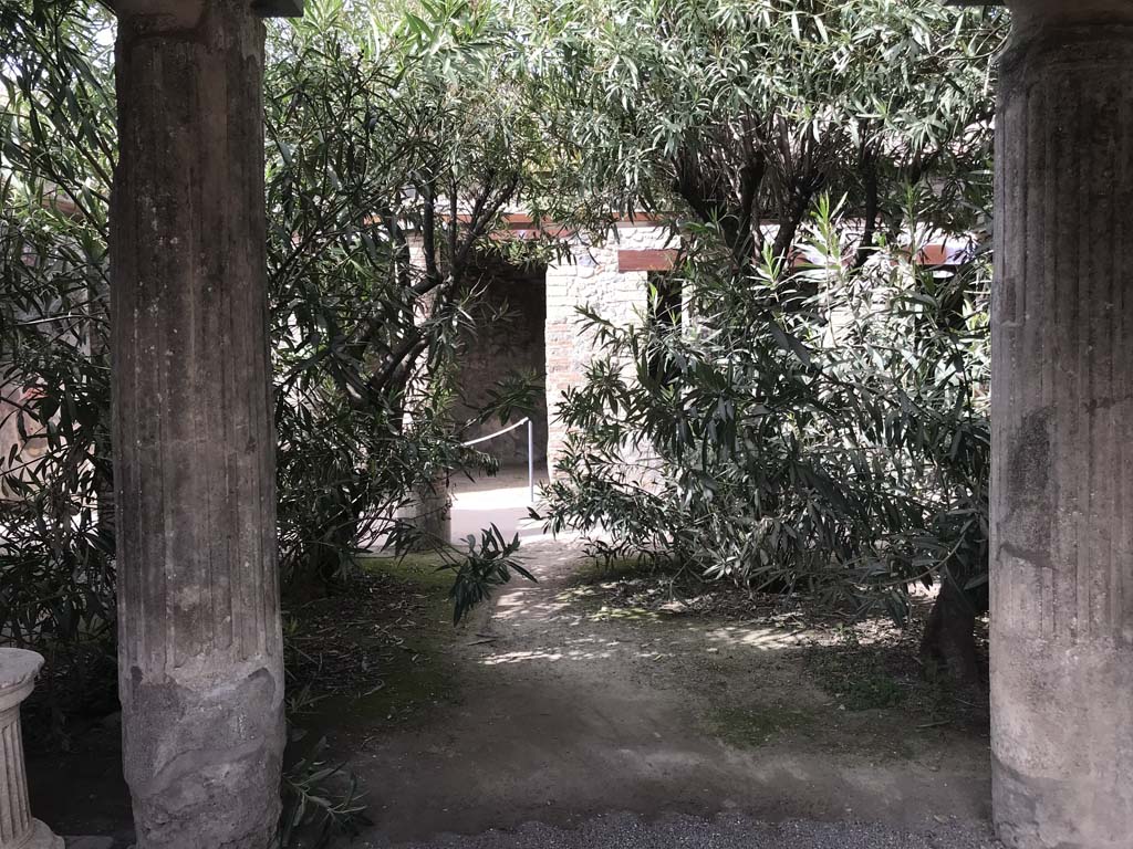 VII.1.25 Pompeii. April 2019. 
Looking west across peristyle 31 towards doorway to exedra 33, and window and doorway to triclinium 32, on right. Photo courtesy of Rick Bauer.
