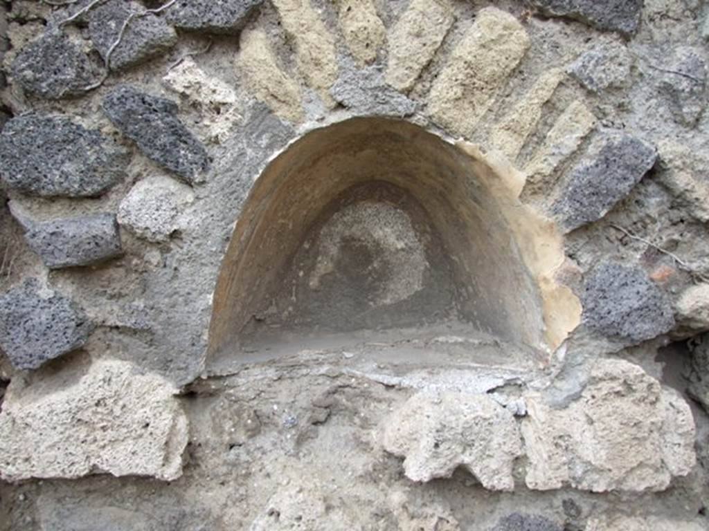 VII.2.12 Pompeii. December 2007. Niche in west wall. According to Boyce, this arched niche had walls coated with white stucco and decorated with broad red bands. Fiorelli called it la nicchia de� Penati.
See Boyce G. K., 1937. Corpus of the Lararia of Pompeii. Rome: MAAR 14. (p.61, 248) 
See Pappalardo, U., 2001. La Descrizione di Pompei per Giuseppe Fiorelli (1875). Napoli: Massa Editore. (p.81)
