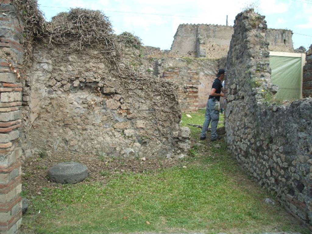 VII.2.37 Pompeii. May 2005. North-east corner of shop, with doorway into atrium of VII.2.38.
