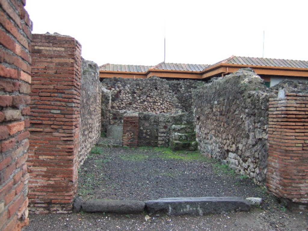 VII.4.3 Pompeii. December 2005. Looking east from entrance. The steps to the upper floor can be seen in the south-east corner of the shop-room, on the right. The doorway to the rear room can be seen in the north-east corner, on the left.  In the rear room, against the east wall, there is a block of tufa stone, found on this was CIL IV 6602.  This block of stone can partly be seen through the doorway. The graffito read -
 M(arcum)  Artor(ium)  II v(irum)  [...]    [CIL IV 6602]
See Varone, A. and Stefani, G., 2009. Titulorum Pictorum Pompeianorum, Rome: L�erma di Bretschneider, (p.355 & photo XXVb)
Eschebach thought it may have been used as a podium ?
See Eschebach, L., 1993. Geb�udeverzeichnis und Stadtplan der antiken Stadt Pompeji. K�ln: B�hlau. (p.272)



