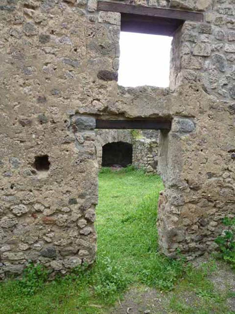 VII.4.39 Pompeii. May 2010. South wall of workshop, with door and window onto rear room of shop.